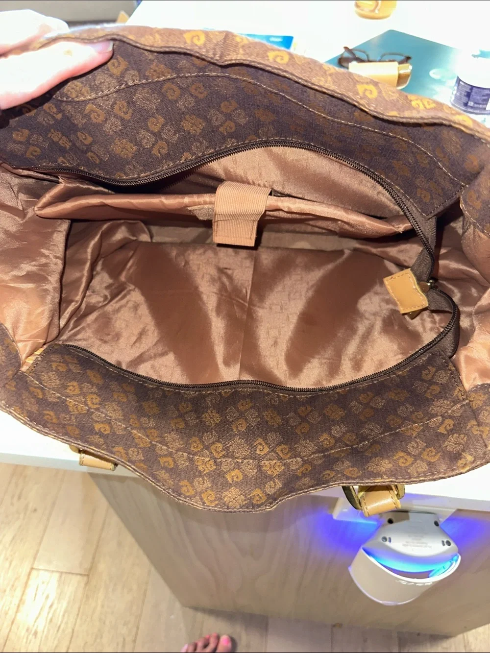This is a brown Pierre Cardin monogram logo tote bag with beige leather handles.